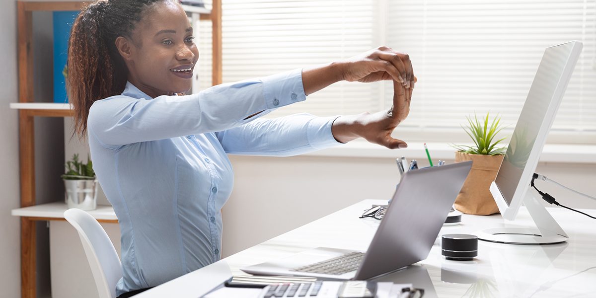 Businesswoman Stretching Her Hand In Office